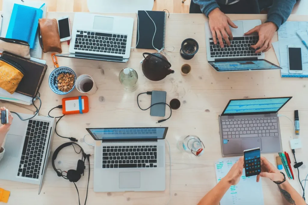 People working at a table with laptops