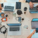 People working at a table with laptops